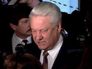 This video clip from the early 1990s captures the intense media frenzy surrounding Boris Yeltsin, a highly visible political figure in Russia during that time. As Yeltsin moves quickly through a crowded area, journalists struggle to keep up with him, jostling and pushing each other to capture the best shot.