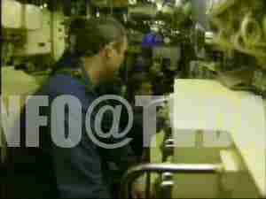Crew member in the control room of a submarine, archival frame.