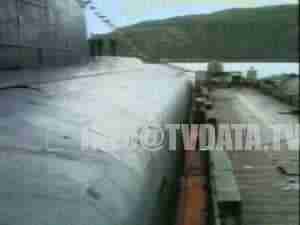 Hull of a submarine alongside a pier, funeral of the Kursk submarine crew, archival frame.