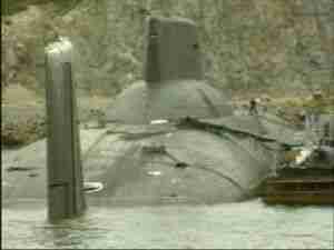 Submarine conning tower and periscope mast at the pier, archival frame from Kursk submarine coverage.