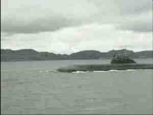 Submarine on the surface in a northern bay, archival frame from Kursk submarine coverage.