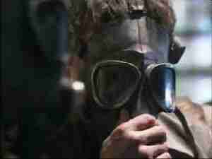 Man in a gas mask, close-up, archival frame from Kursk submarine coverage.