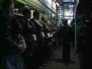Crew lined up in a submarine corridor, archival frame from Kursk submarine coverage.