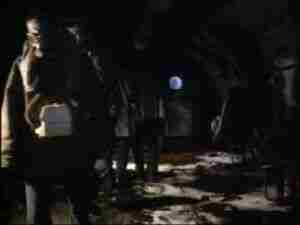 Men working at night in low light, archival frame from Kursk submarine coverage.