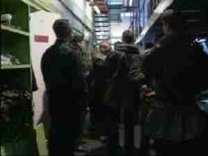Group of officers and crew in a submarine corridor, archival frame from Kursk submarine coverage.