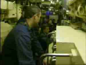 Crew member in the control room of a submarine, archival frame from Kursk submarine coverage.