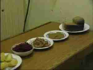 Bread and plates on a table in a submarine galley, archival frame from Kursk submarine coverage.