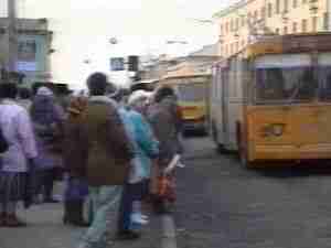 People boarding buses on a city street, archival frame from Chernobyl nuclear accident coverage.