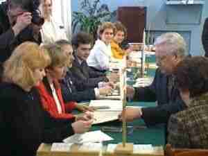 Officials at a long table during a meeting, archival frame from Chernobyl nuclear accident coverage.