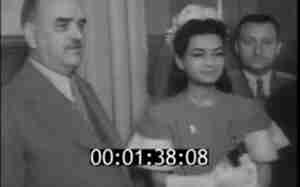 Shah Mohammad Reza Pahlavi with his wife, black-and-white archival film frame with timecode, 1940s Iran.