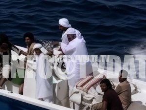 Archival 1987 news footage showing local boat passengers and crew on a small motorboat in the Persian Gulf region, near the Strait of Hormuz. The shot provides human and regional context for a wider story about oil tankers, naval escorts, maritime routes, Gulf communities, and shipping security during the Iran–Iraq War era.