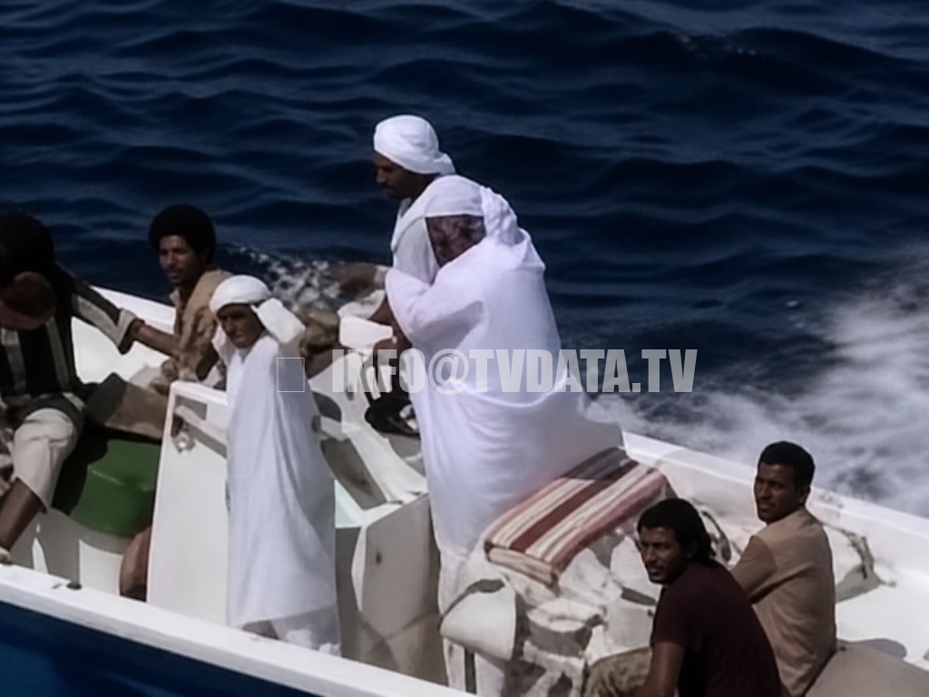 Archival 1987 news footage showing local boat passengers and crew on a small motorboat in the Persian Gulf region, near the Strait of Hormuz. The shot provides human and regional context for a wider story about oil tankers, naval escorts, maritime routes, Gulf communities, and shipping security during the Iran–Iraq War era. Archival 1987 news footage showing local boat passengers and crew on a small motorboat in the Persian Gulf region, near the Strait of Hormuz. The shot provides human and regional context for a wider story about oil tankers, naval escorts, maritime routes, Gulf communities, and shipping security during the Iran–Iraq War era.